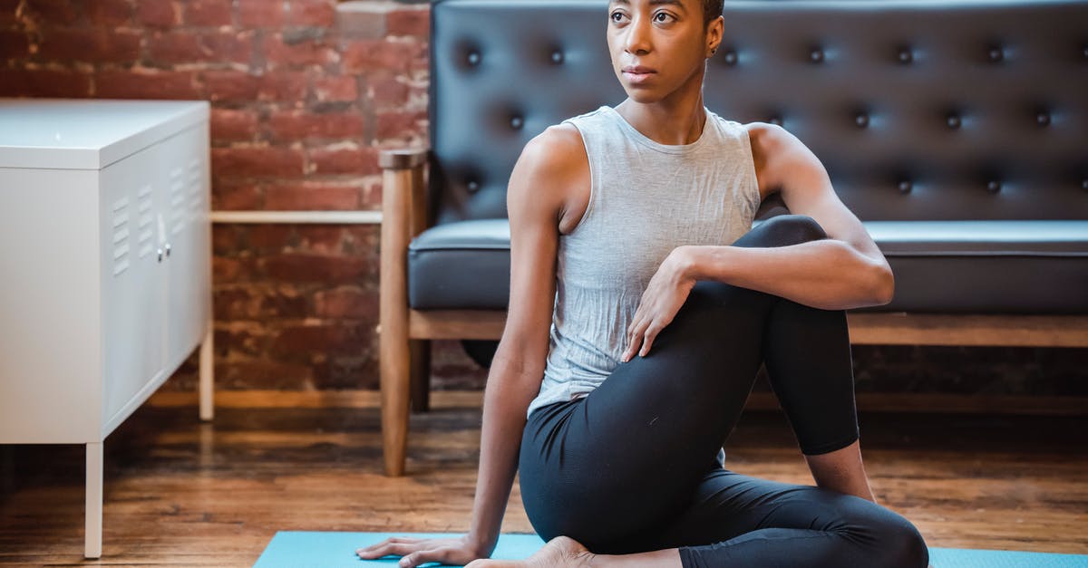 Half of my training missions are missing - Focused black woman exercising Ardha Matsyendrasana posture Half of my training missions are missing - Focused black woman exercising Ardha Matsyendrasana posture
