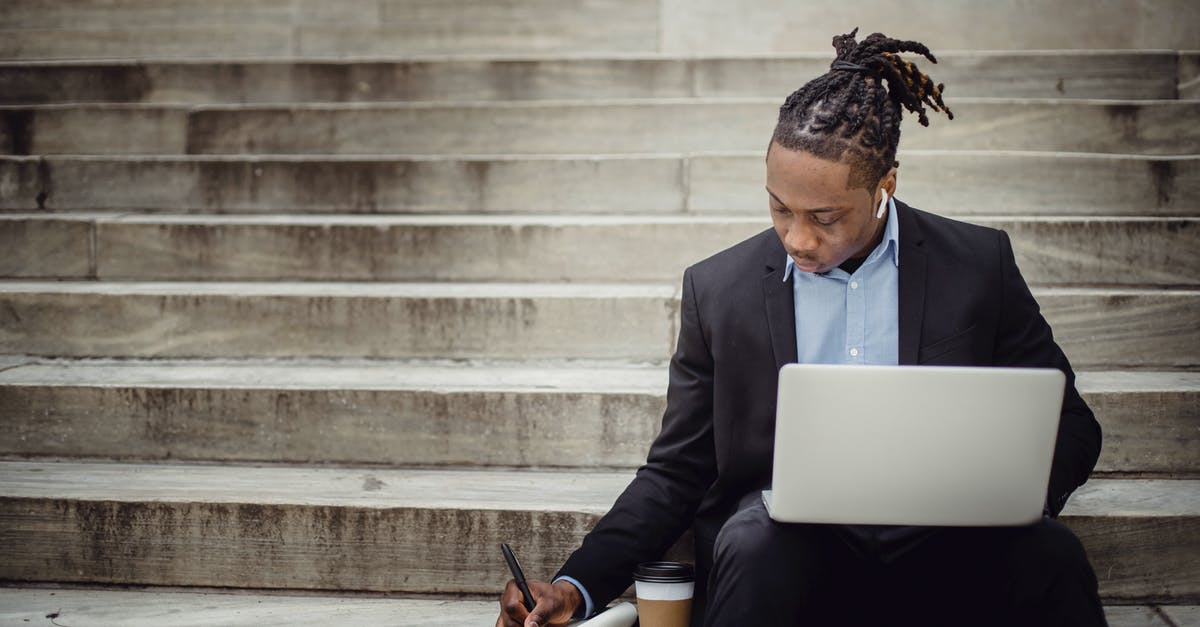 Has Pokémon GO changed their distance algorithm? - Concentrated young black man with dreadlocks in elegant suit browsing laptop and writing out information in notebook while sitting on stairs with takeaway coffee