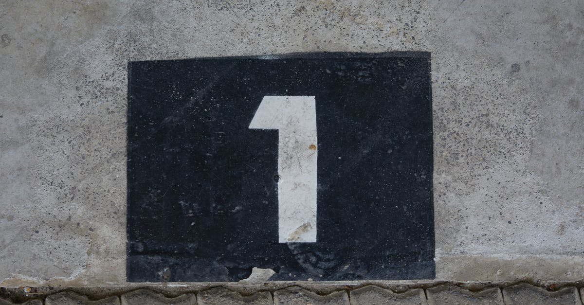 Have a dwarf build a wall one Z level lower than he is - Sign with house number on wall