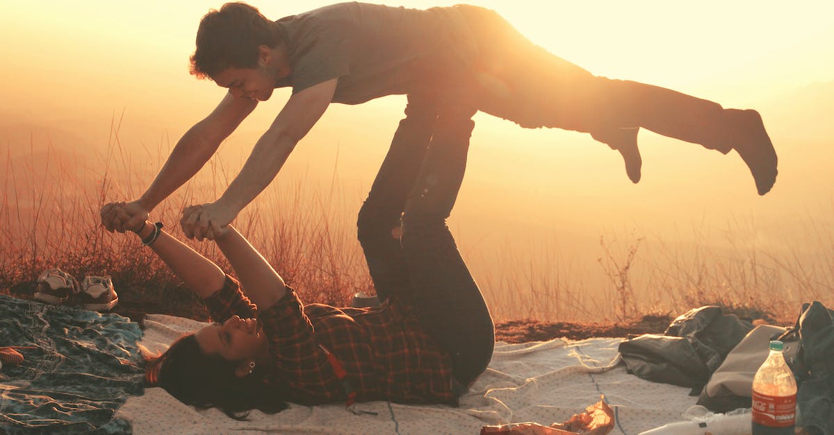 Have we completed Diablo 3 in 9 hours? - Woman Lying on Blanket Under Man on Her Legs Holding Hands during Golden Hour