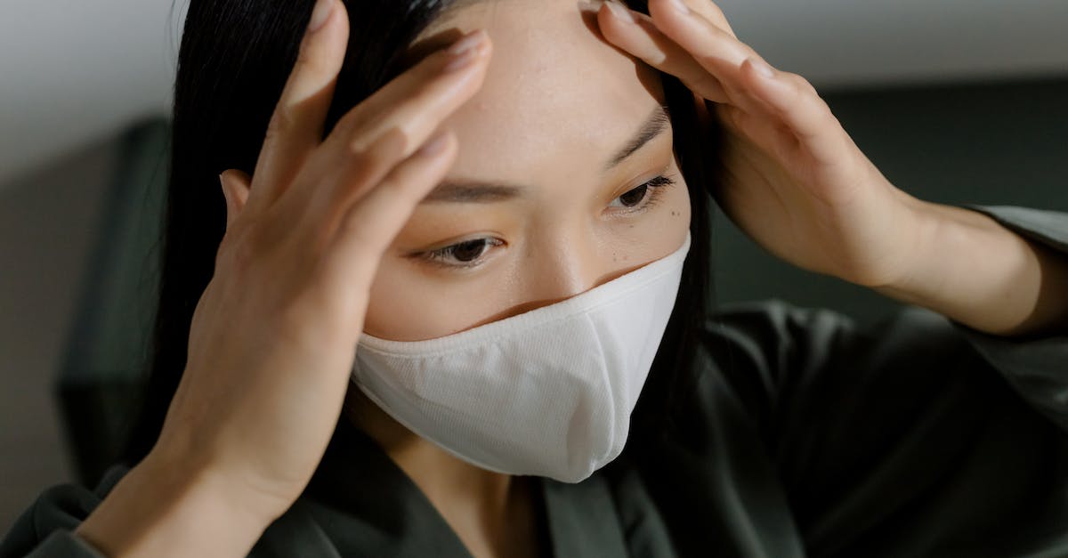 Head-on Collision Prevention - Woman in Black Suit Covering Face With White Face Mask