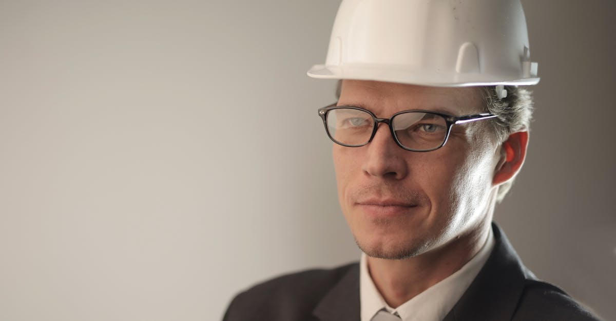 Helmet headshot protection for face shot? - Man in Black Suit Jacket Wearing Hard Hat Helmet headshot protection for face shot? - Man in Black Suit Jacket Wearing Hard Hat