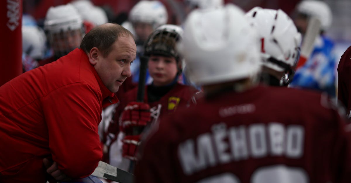 Help finding a Minecraft friend on whatever server that I don't play on or know [closed] - Male trainer talking with children in hockey uniform at ice rink during break of hockey game