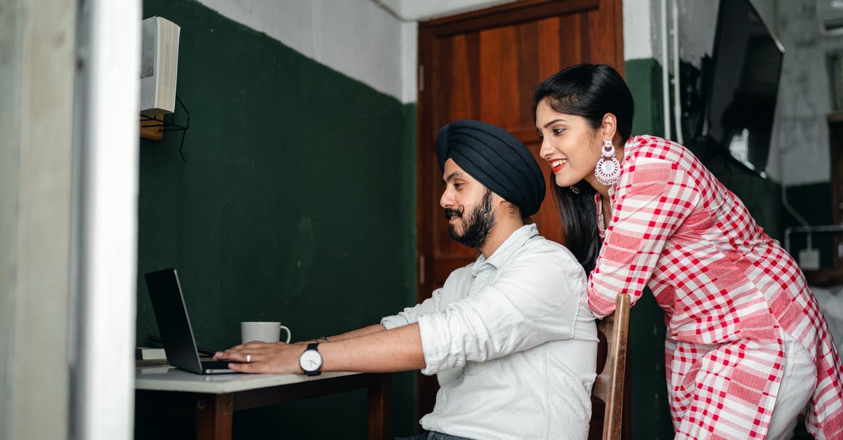 Help getting this command to work on minecraft 1.8.8 [closed] - Side view of positive young Sikh man in shirt and turban working on laptop at home while wife leaning on chair behind