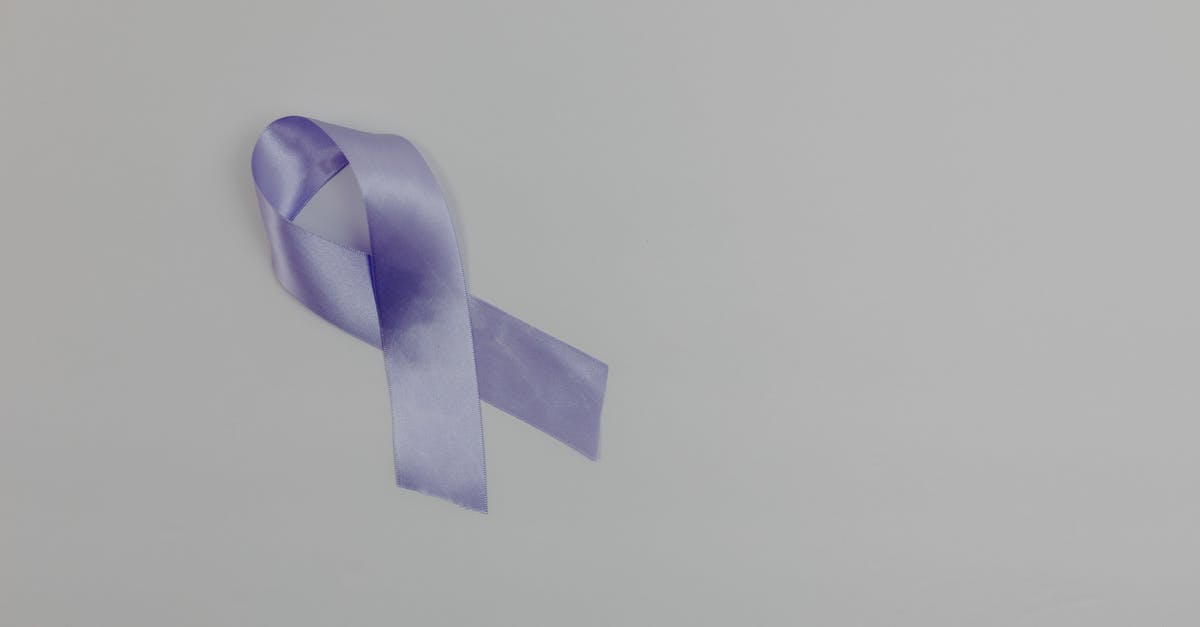 Help With (supposedly) Simple Command - Lavender ribbon representing cancer awareness and support for people with disease placed on white background with copy space in light studio Help With (supposedly) Simple Command - Lavender ribbon representing cancer awareness and support for people with disease placed on white background with copy space in light studio