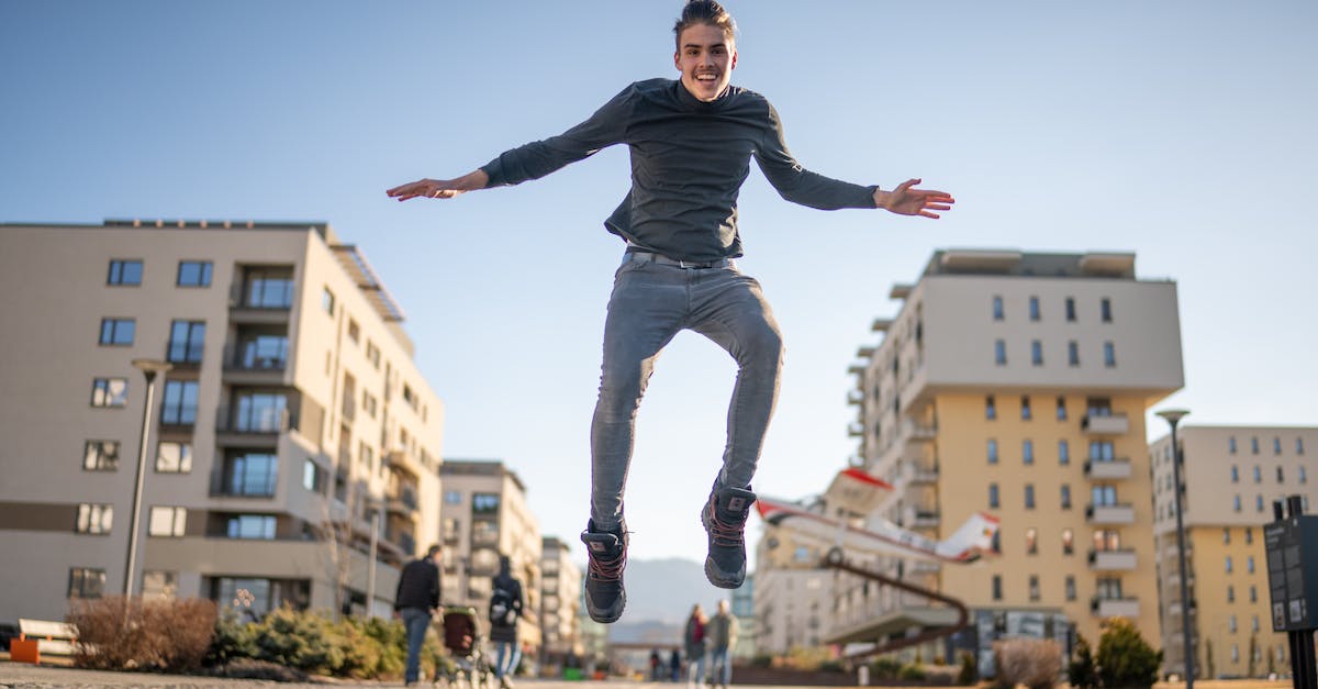 Highest Jump Boost - Man in Black Long Sleeve Shirt and Blue Denim Jeans Highest Jump Boost - Man in Black Long Sleeve Shirt and Blue Denim Jeans