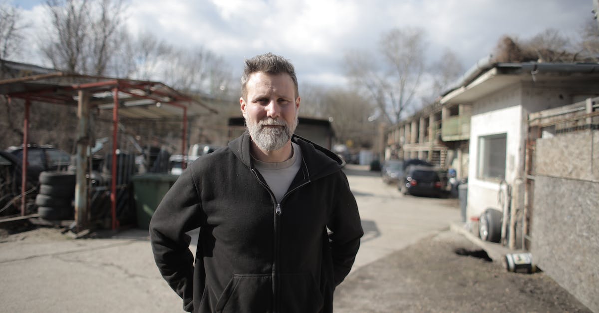 Horde battles in Master Orders? - Smiling male mechanic standing near garage