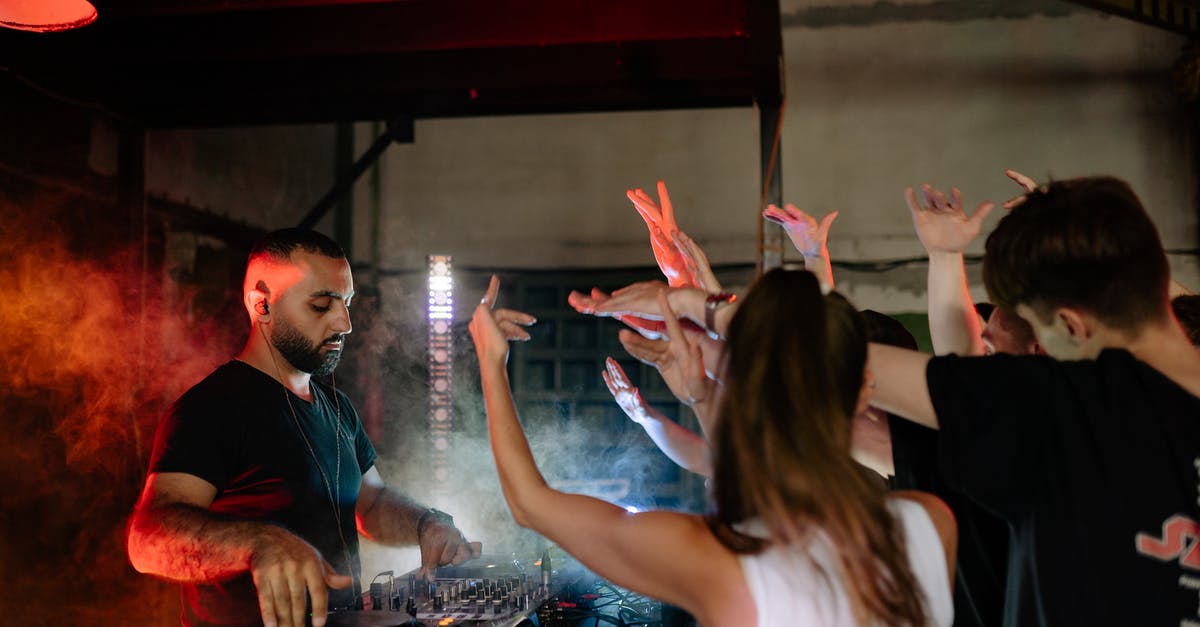 How am I playing on the installation disc? - A Disc Jockey Playing Music in Front of the Crowd