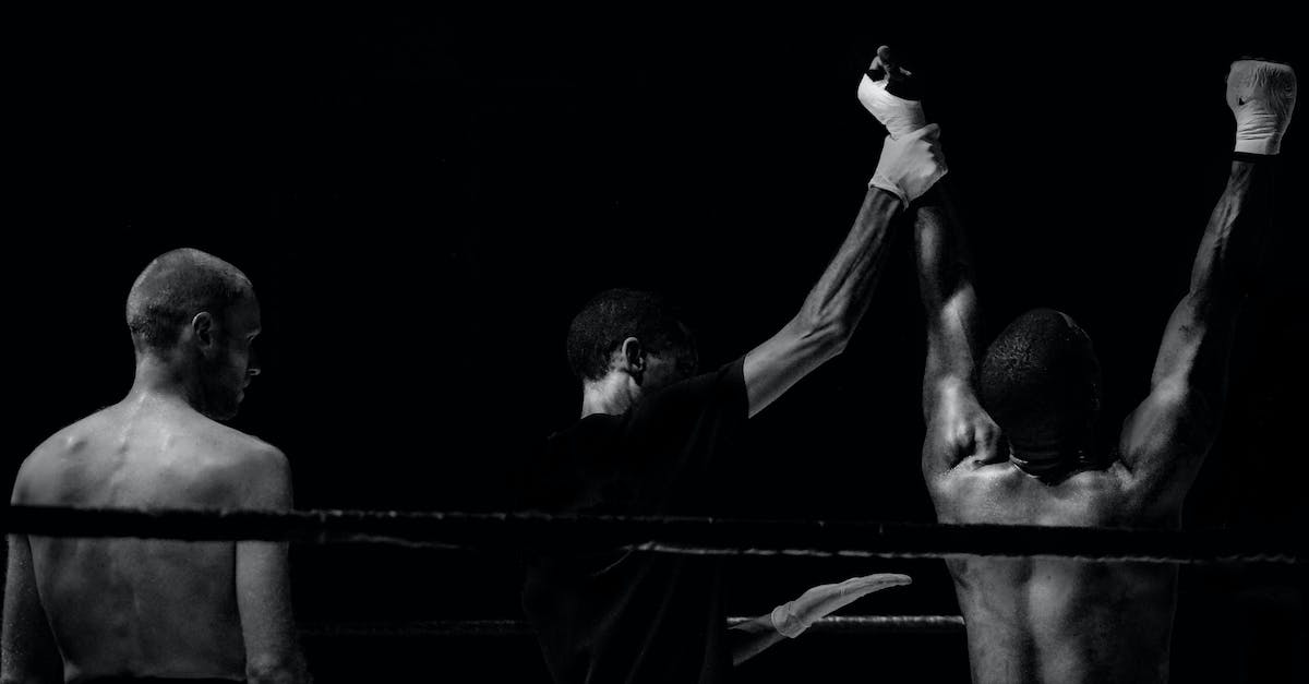 How am I supposed to win the last fight? - Grayscale Photography of Man Holding Boxer's Hand Inside Battle Ring