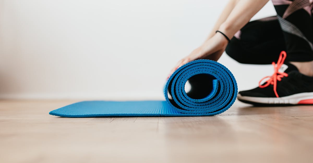 How are my Pokemon selected to enter gym battle? - Crop young sportswoman unfolding blue fitness mat How are my Pokemon selected to enter gym battle? - Crop young sportswoman unfolding blue fitness mat