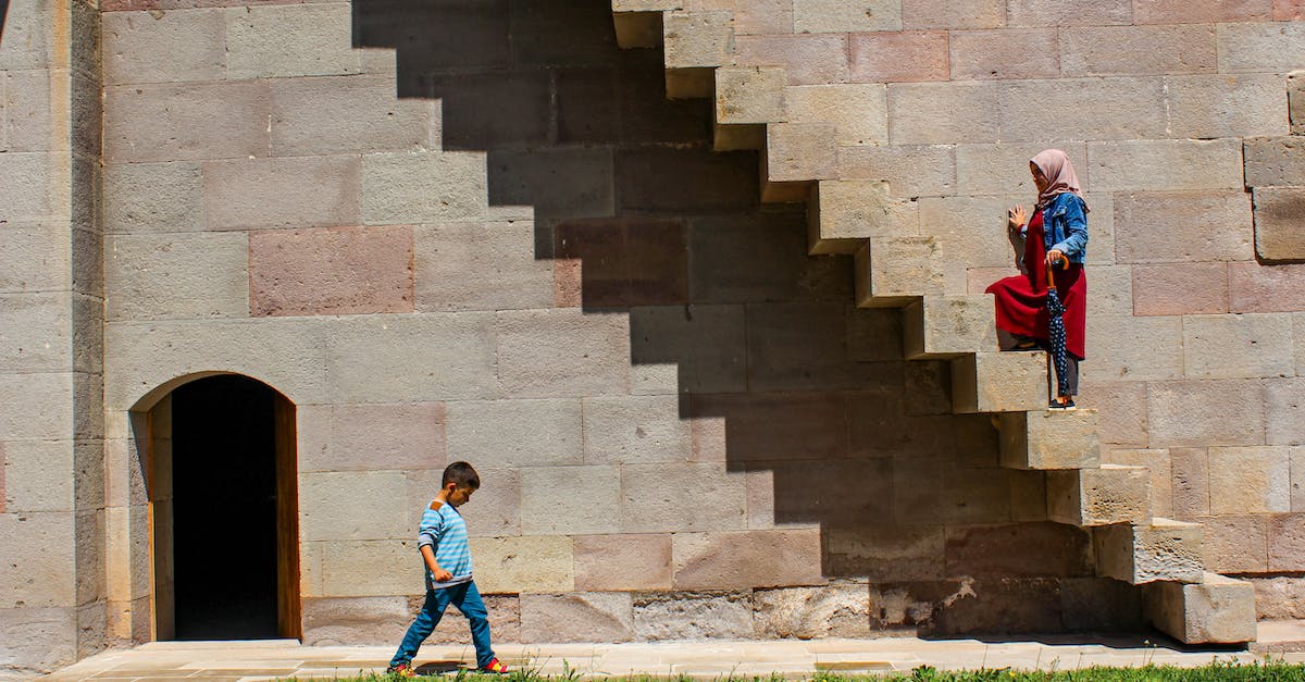 How can I beat the enemies on the castle stairs? - Woman Walking Up the Stairs on the Exterior of an Old Building 