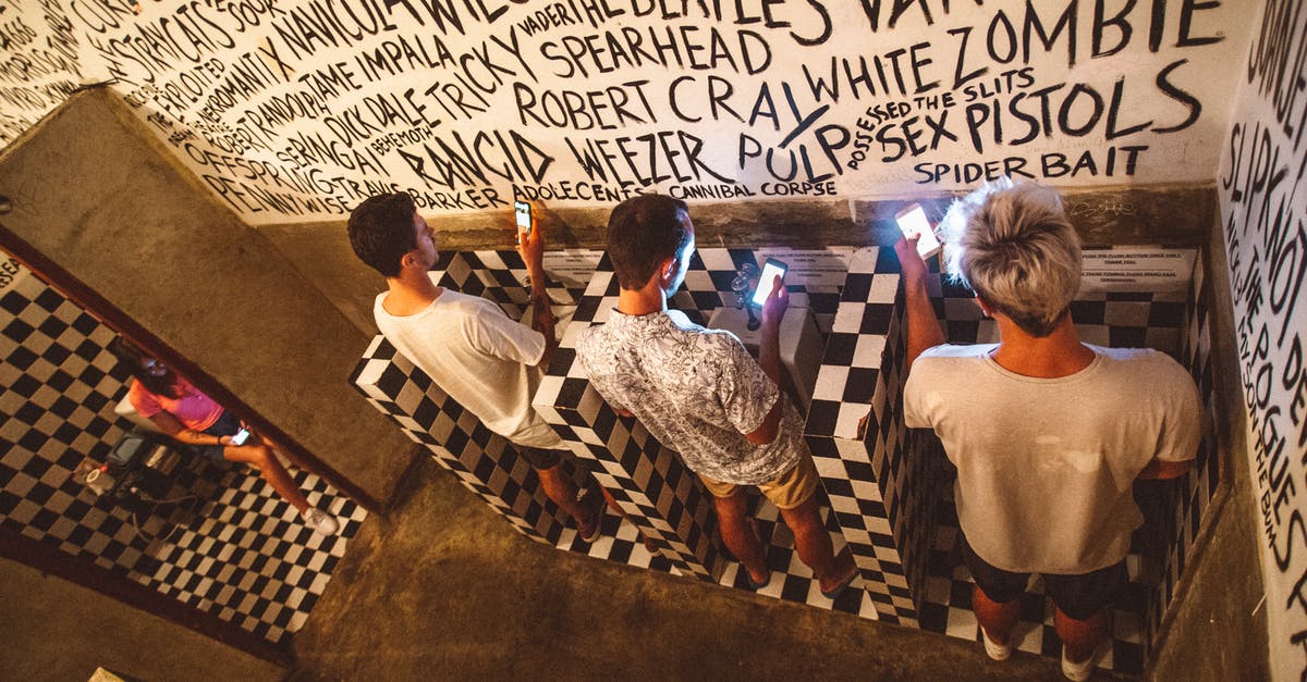 How can I browse public games in Diablo 3? - From above full length faceless people in casual clothes using mobile phones in public toilet with black and white tiles and inscriptions on walls gadget addiction concept