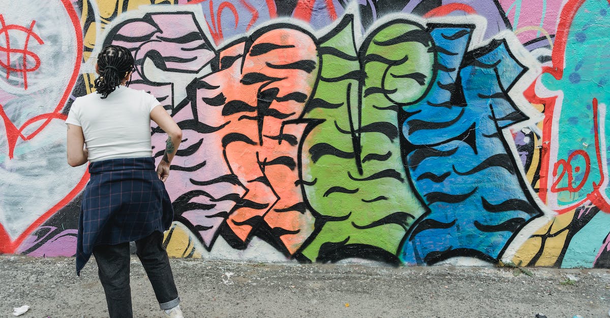 How can I build a boat? - Unrecognizable woman painting creative graffiti