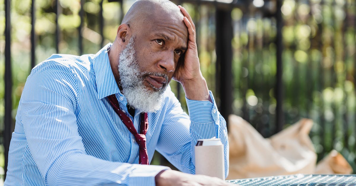 How can I change who is the leader of my party? - Thoughtful African American man sitting at table with tin can How can I change who is the leader of my party? - Thoughtful African American man sitting at table with tin can