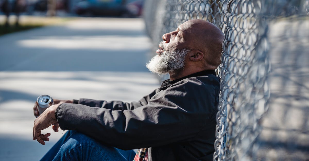 How can I check the status of battle.net? - Man in Black Jacket Leaning on Gray Metal Fence