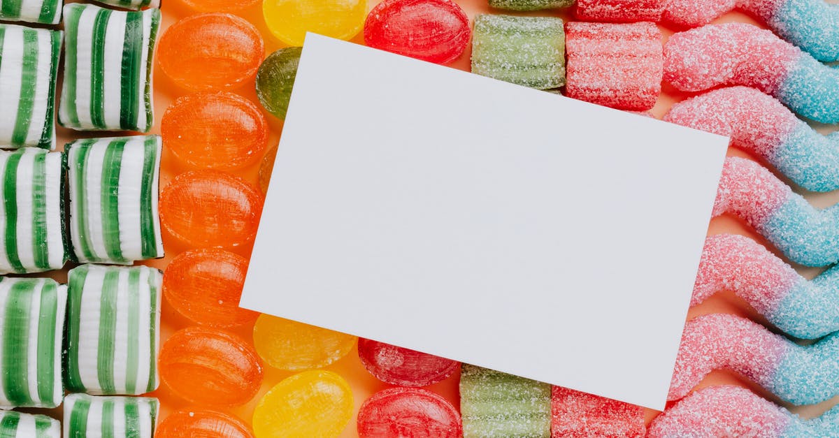 How can I check when a PSN gift card “top-up card” got used? (Or maybe other meta data about its use.) - Closeup from above of white paper card composed on rows of delicious caramel gummy jelly sweets in modern candy shop