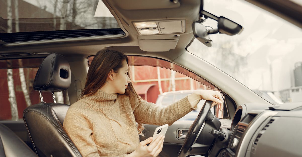 How can I check whether a city Network Node has already been linked to an Alien Artifact? - Adult woman sitting in car and using smartphone