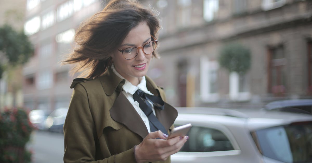 How can I check whether a city Network Node has already been linked to an Alien Artifact? - Stylish adult female using smartphone on street