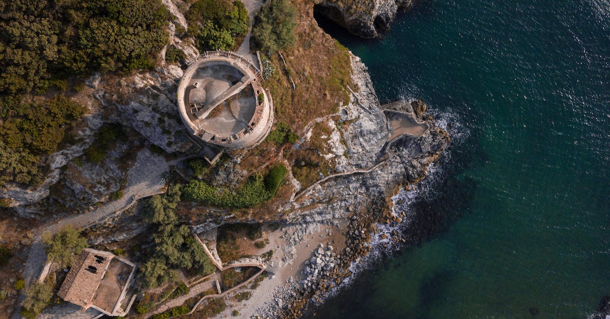 How can I complete the Factory Fort defense level? - Aerial view of medieval fortress on green seashore