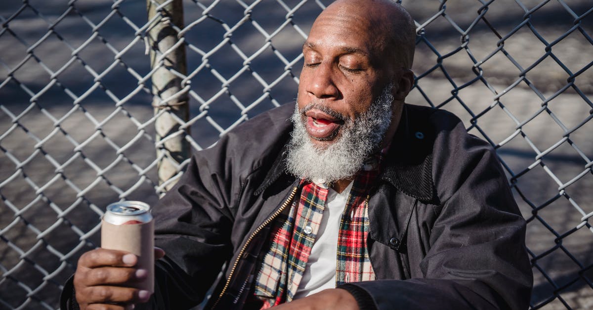 How can I contact Battle Net? - African American homeless man holding beer on street