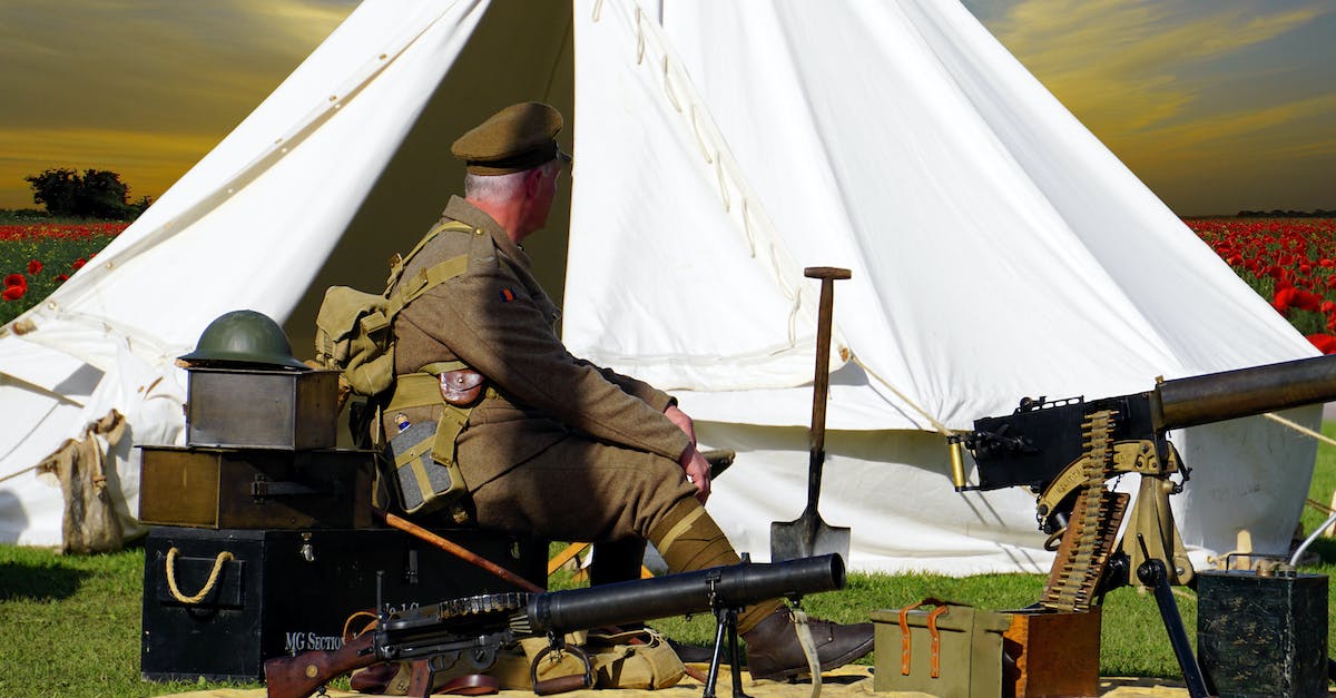 How can I deploy my machine gun without any enemies around? - Man Sitting on Chair Near White Tent How can I deploy my machine gun without any enemies around? - Man Sitting on Chair Near White Tent