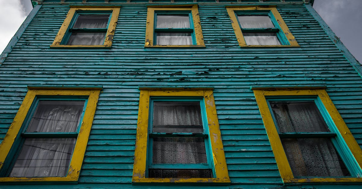 How can I destroy a block from afar? - From below of aged residential house with shabby cracked paint on bright wall under cloudy sky How can I destroy a block from afar? - From below of aged residential house with shabby cracked paint on bright wall under cloudy sky