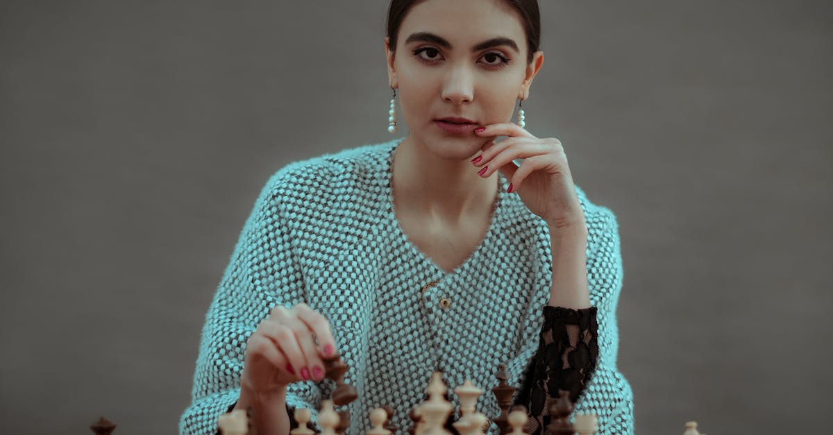 How can I detect if a player is wearing a specific piece of armour? - Focused ethnic female player making chess move while playing game at table against gray background How can I detect if a player is wearing a specific piece of armour? - Focused ethnic female player making chess move while playing game at table against gray background