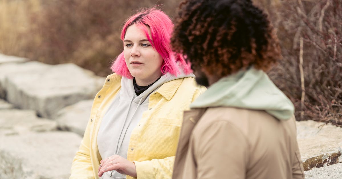 How can I determine my current relationship status? - Calm plump female with pink hair and can of soda in hand sitting near faceless African American man during date