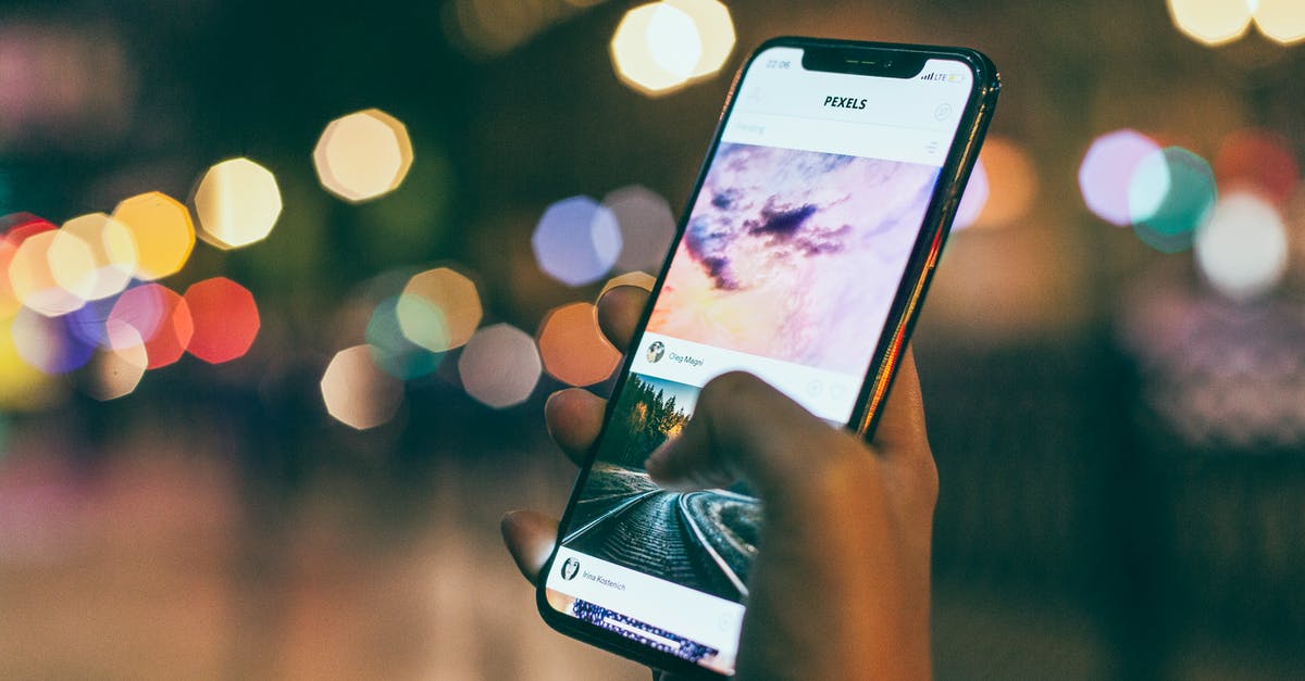 How can I disable banshee screams in Mass Effect 3 multiplayer? - Bokeh Photography of Person Holding Turned-on Iphone