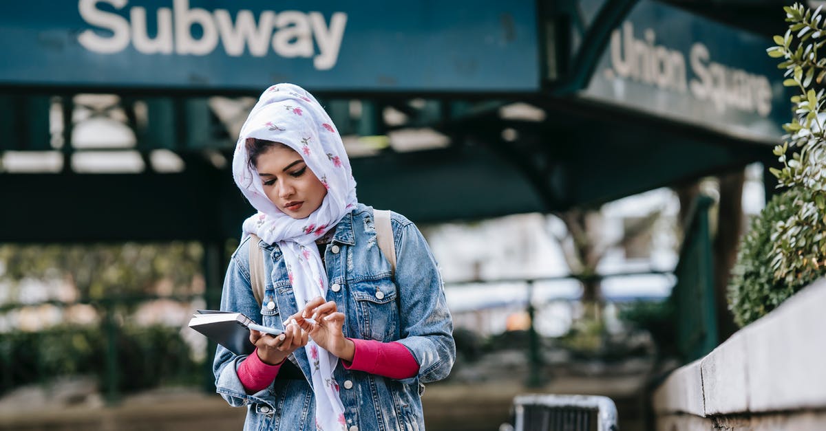 How can I disable Quick Chat in Among Us on the Nintendo Switch? - Serious ethnic woman messaging via smartphone while standing near subway