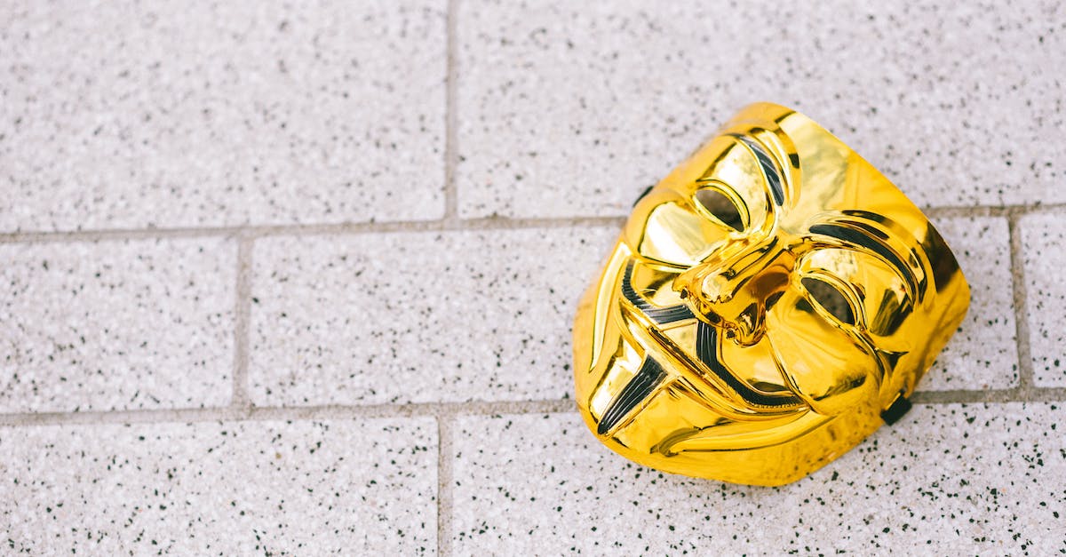 How can I disable Street Fighter IV from lowering my volume during multiplayer battles? - From above of colorful yellow anonymous mask representing protest symbol on rough walkway in daylight