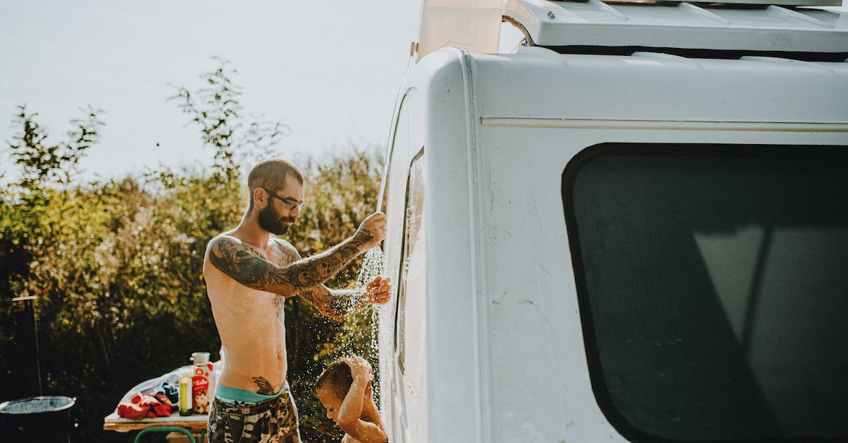 How can I divert a caravan in short notice? - Man with Tattoos Giving Shower to His Son in front of the Caravan How can I divert a caravan in short notice? - Man with Tattoos Giving Shower to His Son in front of the Caravan
