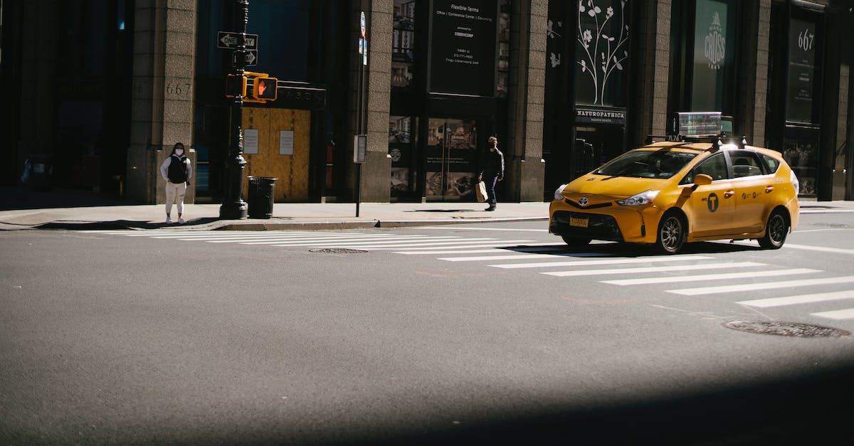 How can I do Taxi missions without waiting? - Yellow cab near zebra crossing and traffic light located against building with stores on street in city on sunny day How can I do Taxi missions without waiting? - Yellow cab near zebra crossing and traffic light located against building with stores on street in city on sunny day