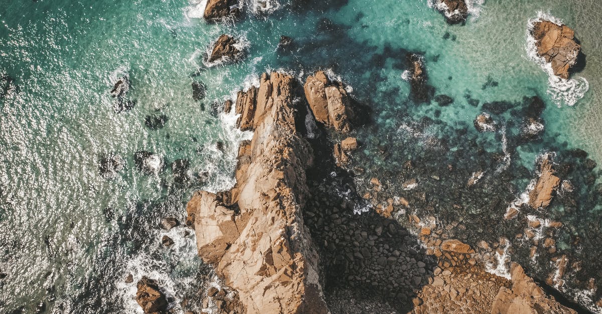 How can I drain all the water in the ocean in minecraft? - Aerial View of Brown Rocky Mountain Beside Body of Water How can I drain all the water in the ocean in minecraft? - Aerial View of Brown Rocky Mountain Beside Body of Water