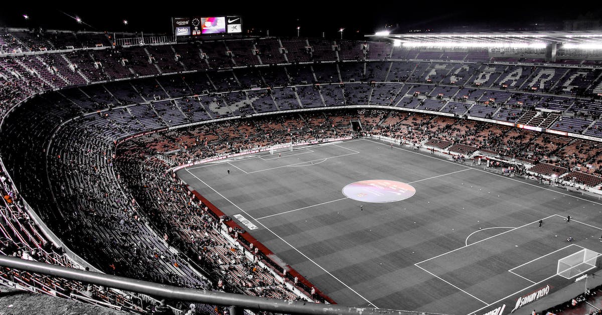 How can I easily remove grass from a large area? - Modern football stadium with spectators on tribunes How can I easily remove grass from a large area? - Modern football stadium with spectators on tribunes