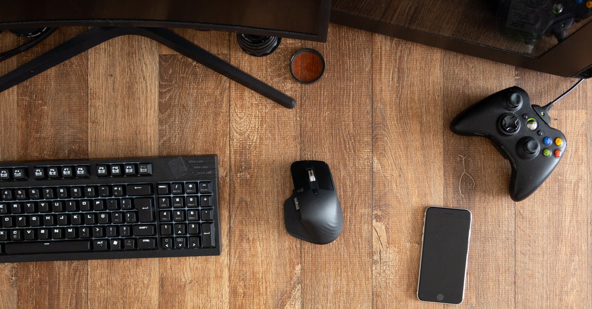 How can I exit to desktop from in-game? - Top view of black gamepad with mouse and keyboard on wooden desk with monitor in apartment in daytime How can I exit to desktop from in-game? - Top view of black gamepad with mouse and keyboard on wooden desk with monitor in apartment in daytime
