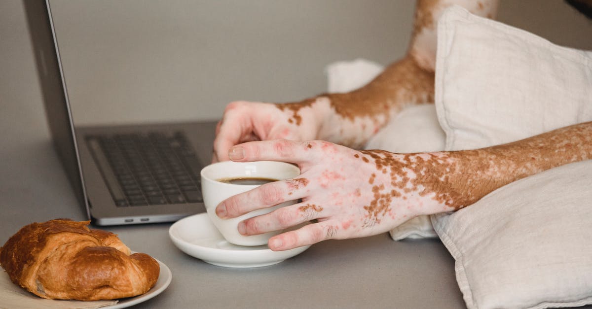 How can I fix "Connection timed out" when connecting to a server after watching youtube or taxing my computer [duplicate] - Crop anonymous male living with psoriasis resting on pillows on floor with modern netbook and enjoying freshly brewed black coffee
