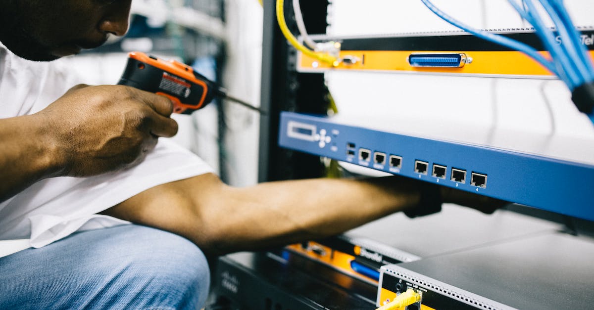 How can I fix the auto-login to the Cerberus network (EA Online) - Side view crop concentrate African American male mechanic in jeans and white shirt using screw gun while working with hardware