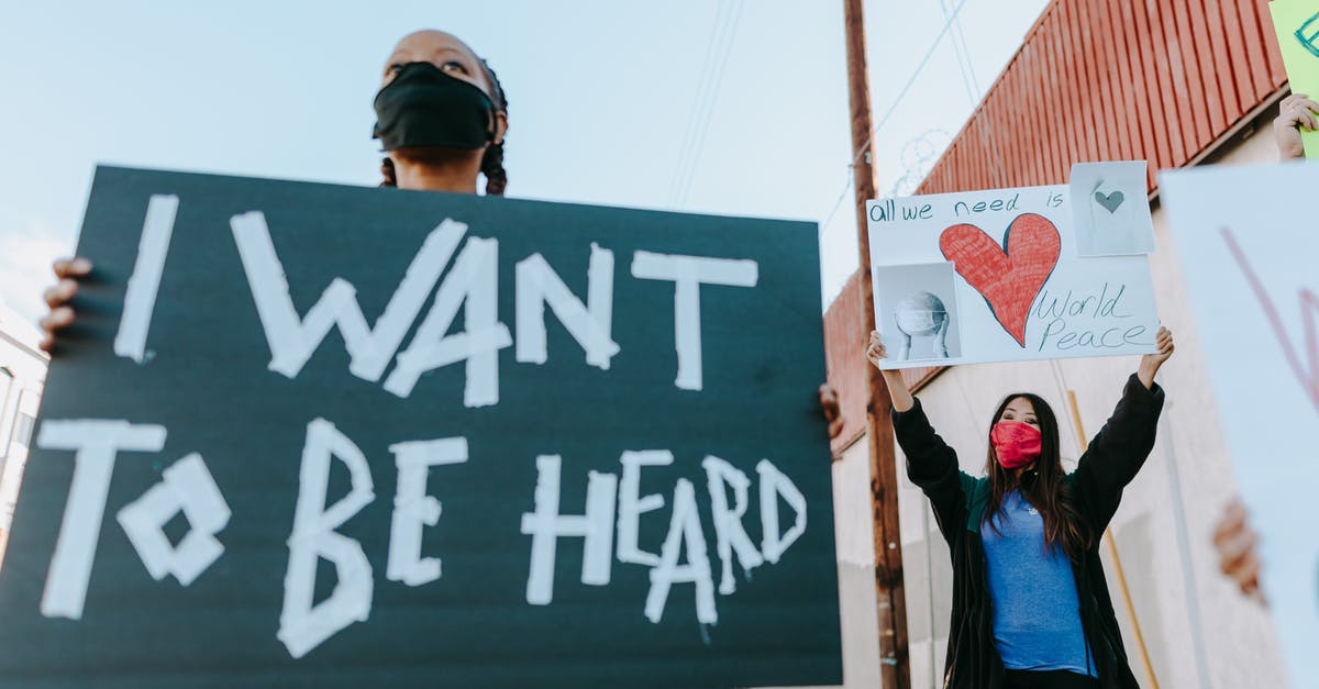 How can I force my Eevee to evolve into the Pokemon I want? [duplicate] - Women Holding Placards while Protesting on the Street