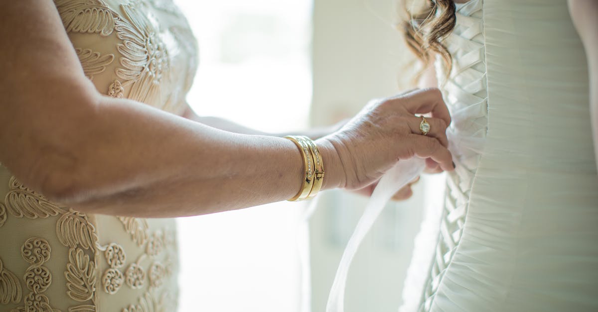 How can I get a wife or daughter in skyrim? [duplicate] - Crop faceless mother lacing up classy wedding dress on daughter