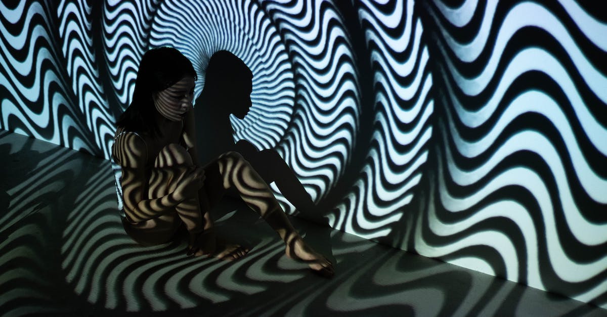 How can I get rid of hallucination side effects? - Woman Sitting on the Floor with Black and White Wavy Stripes