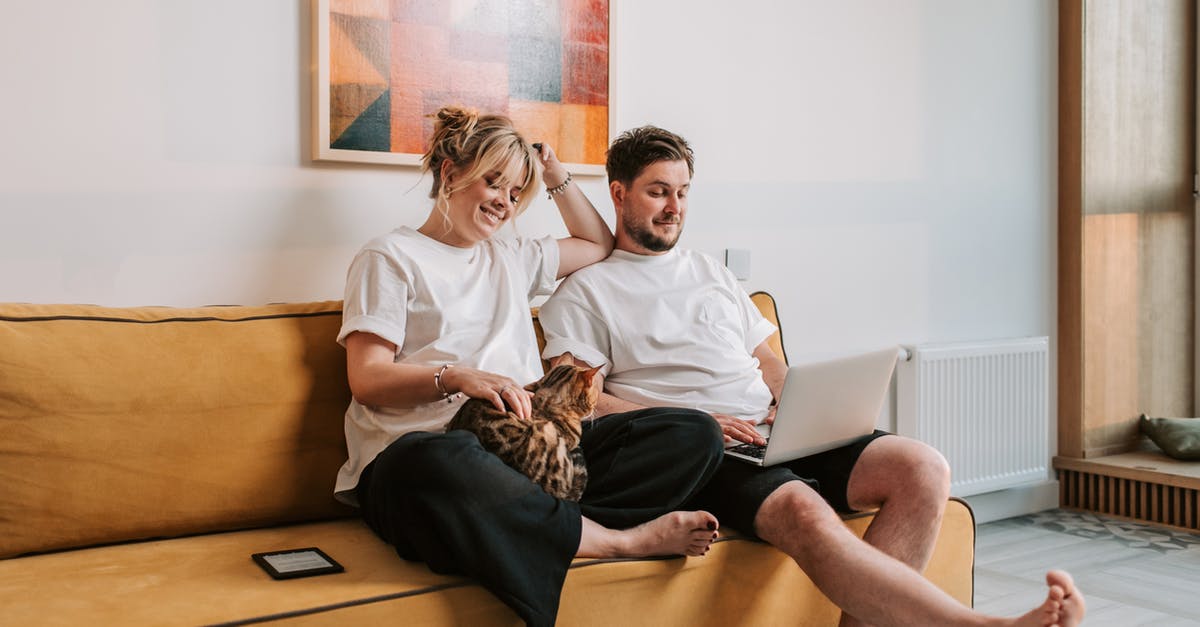 How can I get this pregnant woman to work? [duplicate] - Couple Sitting on Sofa at Home