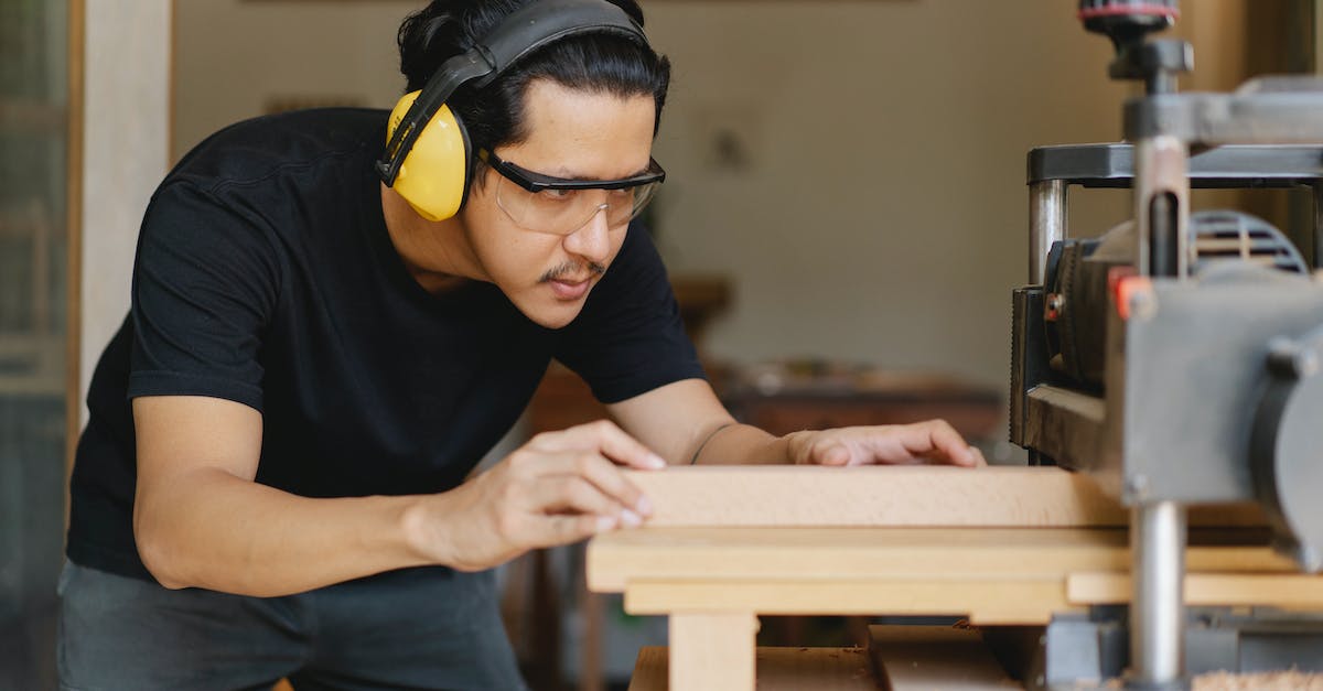 How can I level gathering professions quickly as a high-level character? - Attentive Asian joiner leveling timber on planer in workshop