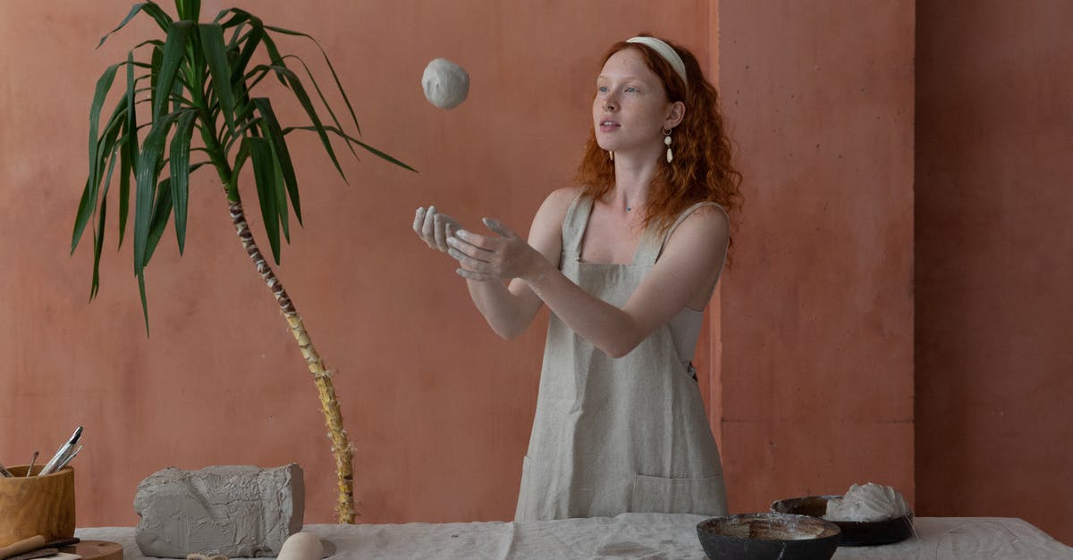 How can I make a command be triggered when an item is throwed? - Young skilled female ceramist wearing light apron throwing clay ball while making ceramic products in modern workshop How can I make a command be triggered when an item is throwed? - Young skilled female ceramist wearing light apron throwing clay ball while making ceramic products in modern workshop