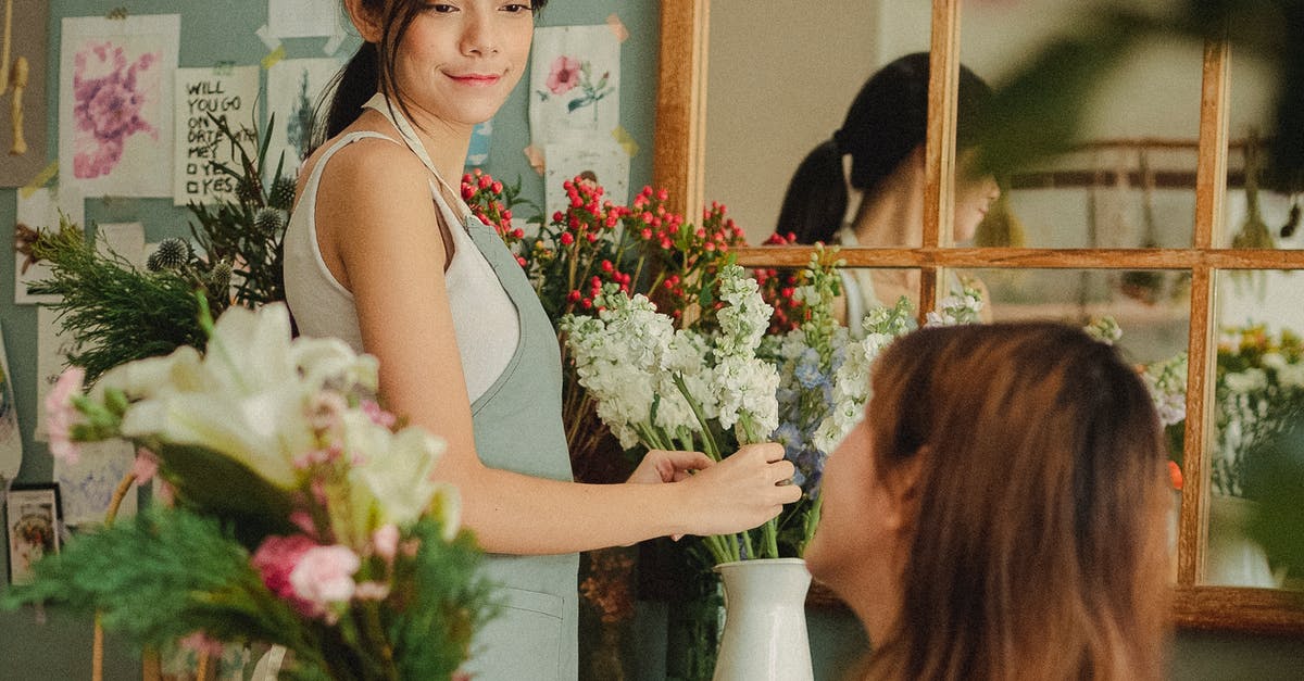 How can I make bullets rotate the other way with the Skimmer? - Side view glad young female florists wearing aprons arranging delicate flowers and looking at each other contentedly while working together in light floral store