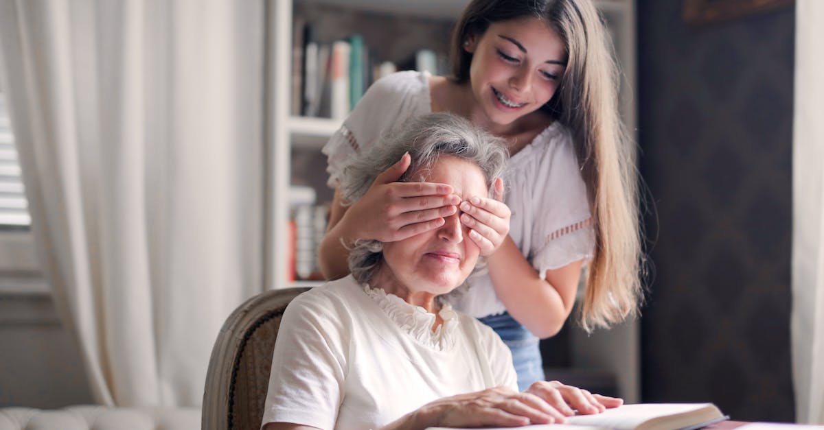 How can I move an installed game from one Steam library folder to another? - From below pensive gray haired woman trying to guess who closing eyes while sitting at table and reading book in light library in cottage