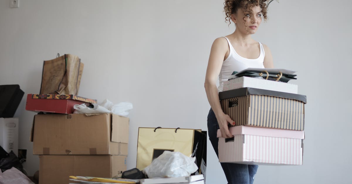 How can I move my family to Lakeview Manor? [duplicate] - Concentrated woman carrying stack of cardboard boxes for relocation
