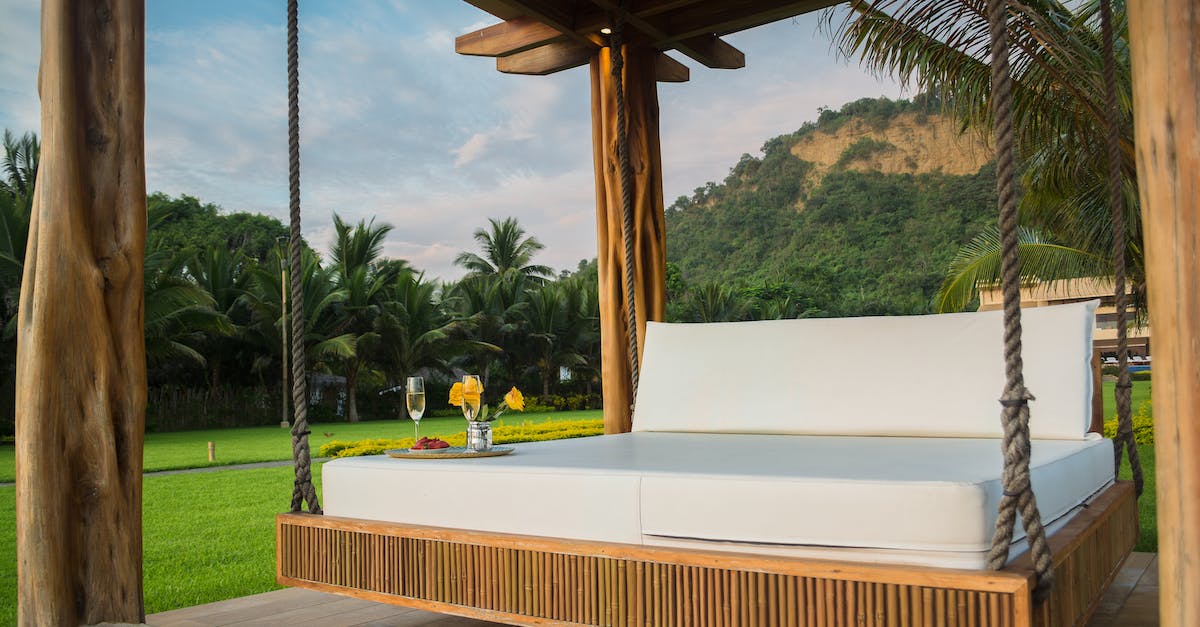 How can I place my bed on glass blocks? - Brown Wooden Framed With White Mattress Hanging Bed Surrounded by Green Grass How can I place my bed on glass blocks? - Brown Wooden Framed With White Mattress Hanging Bed Surrounded by Green Grass