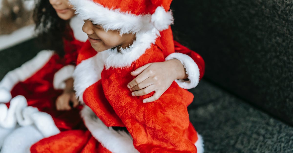 How can I play the content from another account on my new Xbox 360 console? [duplicate] - Crop cheerful African American kids wearing red Santa costumes and hats embracing and sitting on cozy couch