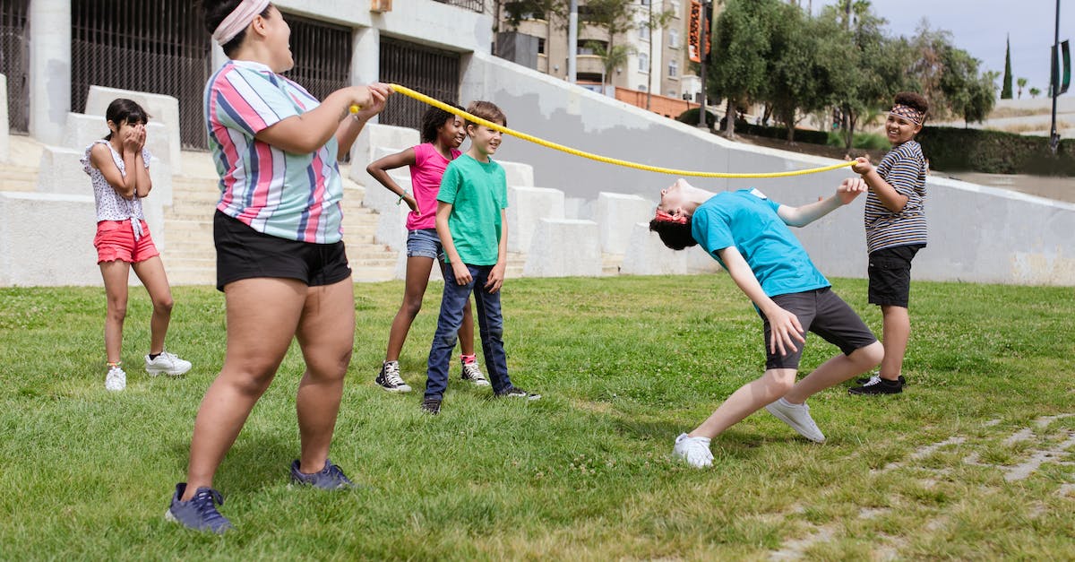 How can I play xbox 360 online games with my friends in Canada and Mexico? - A Boy Bending Her Body Under the Rope